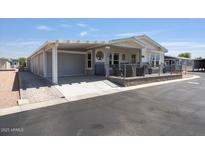 Charming single-story home with covered porch and attached carport, offering comfort and convenience at 2206 S Ellsworth Rd # 160B, Mesa, AZ 85209