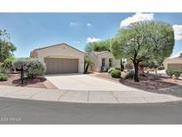 Charming single-story home featuring a tile roof, desert landscaping, and a spacious two-car garage at 23309 N Las Positas Ct, Sun City West, AZ 85375