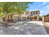 Spacious two-story home with a three-car garage and desert landscaping, perfect for Gathering living at 29475 N Candlewood Dr, San Tan Valley, AZ 85143