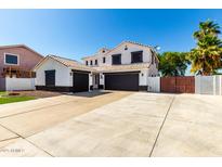 Two-story home featuring a three-car garage and well-manicured landscaping at 3444 E Flamingo Ct, Gilbert, AZ 85297