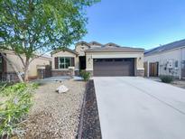 Charming single-story home featuring a well-maintained front yard and a two-car garage at 42099 W Balsa Dr, Maricopa, AZ 85138