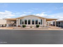 Inviting single-story home featuring covered patios, manicured landscaping, and a welcoming facade at 5735 E Mcdowell Rd # 388, Mesa, AZ 85215