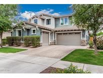 Beautiful two-story home featuring a three-car garage and manicured front lawn at 7528 E Peralta Ave, Mesa, AZ 85212