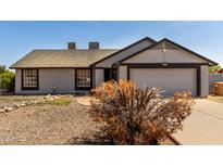 Charming single-level home with a neutral color scheme and a well-maintained front yard at 8703 W Golden Ln, Peoria, AZ 85345