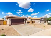 Charming single-story home featuring a two-car garage, low maintenance landscaping, and tile roof at 9332 W Mary Ann Dr, Peoria, AZ 85382