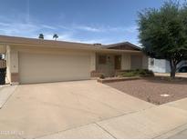 Charming single-story home with desert landscaping, two car garage and front yard at 108 E Jasmine St, Mesa, AZ 85201