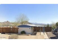 Cozy home with covered patio and privacy fence set against beautiful mountain views at 13013 N 18Th St, Phoenix, AZ 85022