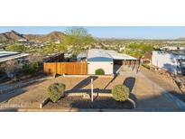 Well-maintained front yard with desert landscaping, a privacy fence, and a covered parking area at 13013 N 18Th St, Phoenix, AZ 85022