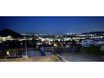 Expansive city views at night from this property overlooking the neighborhood and mountains in the distance at 13013 N 18Th St, Phoenix, AZ 85022