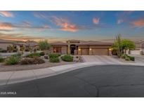 Beautiful single story home at dusk with desert landscaping, warm lighting, and an inviting driveway at 14708 E Canyoncrest Ct, Fountain Hills, AZ 85268