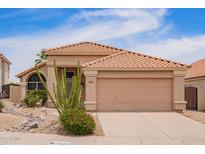 Charming single-story home featuring a well-maintained yard with desert landscaping and a neutral color palette at 15827 S 12Th Pl, Phoenix, AZ 85048