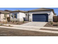 Charming single-story home featuring a blue garage door, desert landscaping, and a well-maintained front yard at 17545 W Victory St, Goodyear, AZ 85338