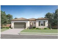 Charming single-story home featuring a tile roof, arched entryway, and a well-manicured lawn at 17545 W Victory St, Goodyear, AZ 85338