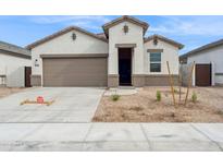 Charming single-Gathering home featuring a two-car garage, neutral stucco and rock landscaping at 17806 W Vogel Ave, Waddell, AZ 85355