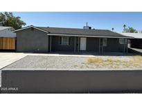 Charming single-story home featuring a gray exterior, low-maintenance yard, and covered front porch at 1915 W Missouri Ave, Phoenix, AZ 85015