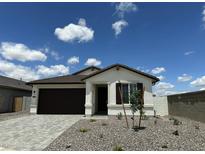 Inviting single-story home with a charming front yard and a spacious driveway at 25332 N 133Rd Ave, Peoria, AZ 85383