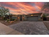 Charming home exterior boasting a paved driveway, desert landscaping and attached two car garage at 3045 W Feather Sound Dr, Phoenix, AZ 85086