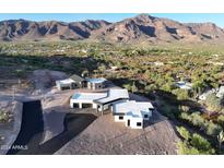 Stunning aerial view of a modern home nestled in a desert landscape with mountain views at 3502 S Kings Ranch Rd, Gold Canyon, AZ 85118