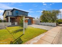 Charming two-story home featuring modern design, brick accents, a well-manicured lawn, and inviting curb appeal at 5533 E Earll Dr, Phoenix, AZ 85018