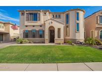 Charming two-story home featuring well-maintained landscaping and a welcoming front entrance at 5628 N Rattler Way, Litchfield Park, AZ 85340