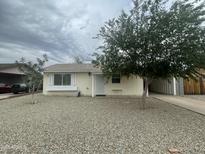 Charming single-story home with mature trees and a low-maintenance gravel yard, offering great curb appeal at 6832 W Vogel Ave, Peoria, AZ 85345