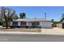 Charming single-Gathering home featuring well-maintained landscaping, a red brick accent, and an attached one car garage at 8502 N 26Th Ave, Phoenix, AZ 85021