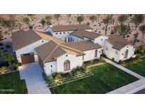 Stunning home showcasing a desert landscape, complemented by a tan tile roof and meticulous landscaping at 11823 N 76Th Way, Scottsdale, AZ 85260
