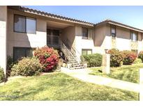 Inviting two-story condo with well-maintained landscaping and stair access to upper units at 1402 E Guadalupe Rd # 215, Tempe, AZ 85283