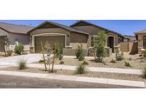 Charming single-story home featuring a two-car garage, desert landscaping, and a welcoming entryway at 15018 W Buckskin Trl, Surprise, AZ 85387
