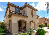 Charming two-story home featuring a welcoming front porch and desert landscaping at 18525 W Valerie Dr, Surprise, AZ 85374