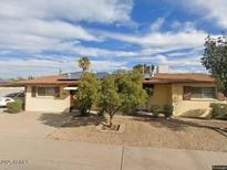 A charming single-story home with a well-maintained front yard and solar panels at 2414 W Cholla St, Phoenix, AZ 85029