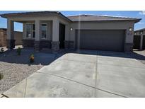 Charming single-story home with a well-manicured yard and an attached two-car garage in a quiet neighborhood at 25096 N 154Th Ln, Surprise, AZ 85387