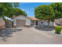 Charming single-story home featuring a well-manicured front yard and a convenient attached garage at 2510 W Columbine Dr, Phoenix, AZ 85029