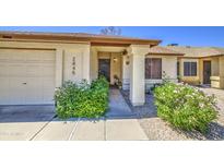 Inviting front entryway with a private two car garage and lush plants at 2845 E Irwin Ave, Mesa, AZ 85204