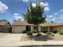 Charming single-story home with a well-manicured, low maintenance front yard and private two car garage at 2845 E Irwin Ave, Mesa, AZ 85204