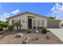 Charming single-story home with desert landscaping, gravel yard, and private two-car garage at 3301 S Goldfield Rd # 1010, Apache Junction, AZ 85119