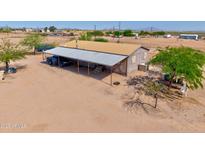 Exterior of a charming home, featuring a metal awning and plenty of open space and natural light at 43384 W Padilla Rd, Maricopa, AZ 85138