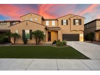 Inviting two-story home featuring a well-manicured lawn, lush palm trees, and an attached two-car garage at 5123 S Mariposa Dr, Gilbert, AZ 85298