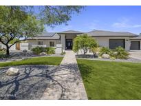 Beautiful home with lush landscaping, stone accents, and a welcoming walkway to the front door at 5926 E Hartford Ave, Scottsdale, AZ 85254