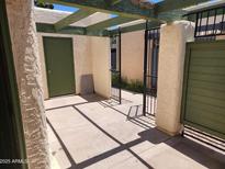 Enclosed patio featuring a gated entrance, olive green door, and rustic-style beamed overhang at 603 S Allred Dr, Tempe, AZ 85281
