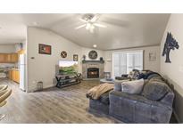 Comfortable living room features a stone fireplace and wood-look flooring at 8111 E 5Th Ave, Mesa, AZ 85208