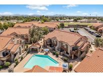Aerial view showcases a refreshing community pool surrounded by well-maintained buildings and landscaping at 839 S Westwood -- # 154, Mesa, AZ 85210