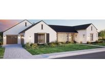 Beautiful two-story home with a stone accent, a manicured lawn, a paver driveway, and a three-car garage at 9801 N 53Rd Pl, Paradise Valley, AZ 85253