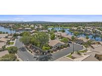 Stunning aerial view of a lakeside home in a scenic neighborhood with lush landscaping and mountain views at 1135 W Sea Fog Dr, Gilbert, AZ 85233