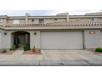 Charming townhome featuring a tile roof, two-car garage, and low-maintenance landscaping at 16021 N 30Th St # 127, Phoenix, AZ 85032