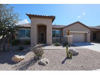 Charming single-story home with desert landscaping and a covered entryway, offering curb appeal and a welcoming facade at 18137 W Deer Creek Rd, Goodyear, AZ 85338