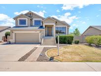 Charming two-story home with a well-maintained lawn and inviting curb appeal on a sunny day at 1903 E Jasper Dr, Chandler, AZ 85225