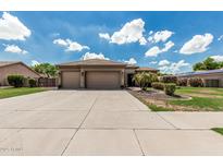Charming single-story home with a tile roof, three-car garage, and well-maintained landscaping at 20826 S Hadrian Way, Queen Creek, AZ 85142