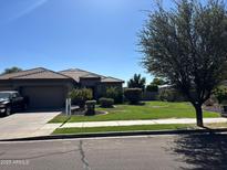 Charming single-story home with well-manicured lawn and mature tree in a desirable neighborhood at 20826 S Hadrian Way, Queen Creek, AZ 85142