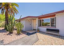 Charming home featuring desert landscaping, a palm tree, and a textured walkway to the front door at 2214 N 7Th Ave, Phoenix, AZ 85007